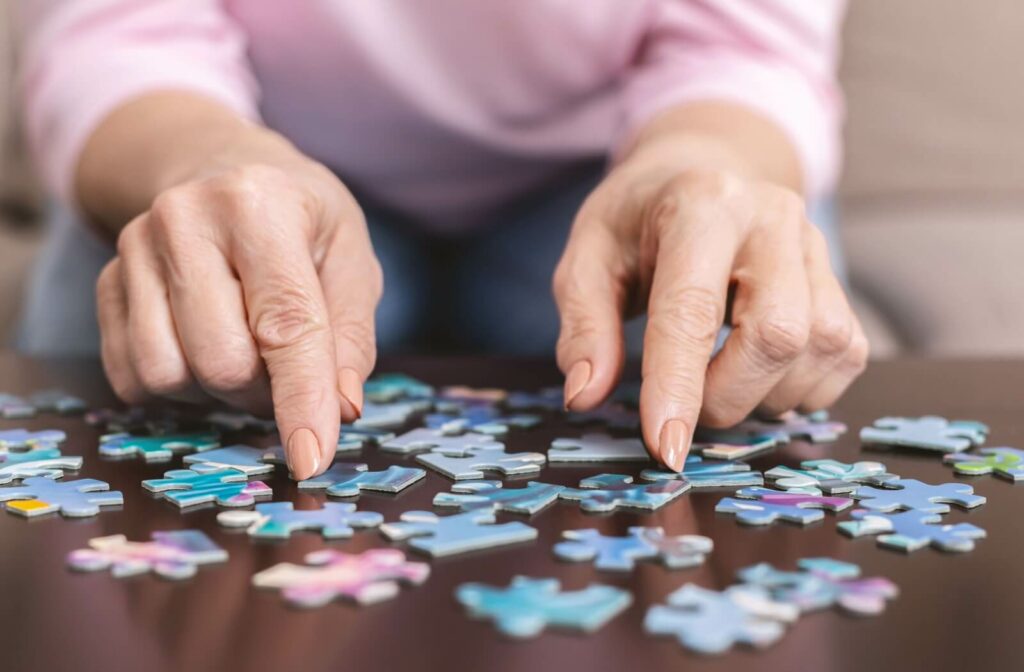 Senior completing a puzzle in memory care to enhance cognitive function.