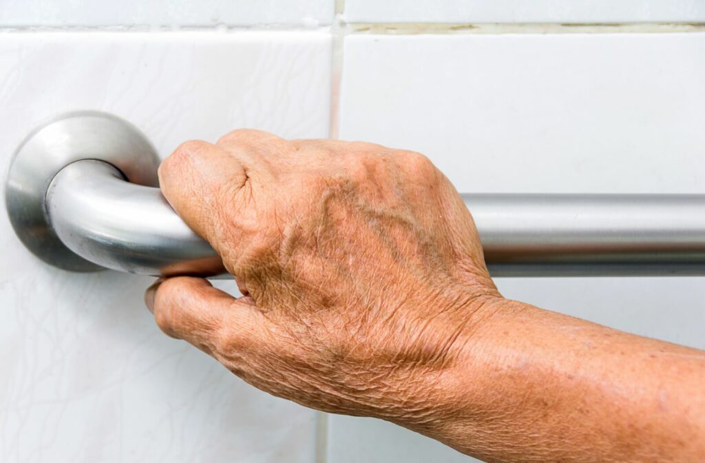 Close up of hand on a bathroom bar to prevent falling