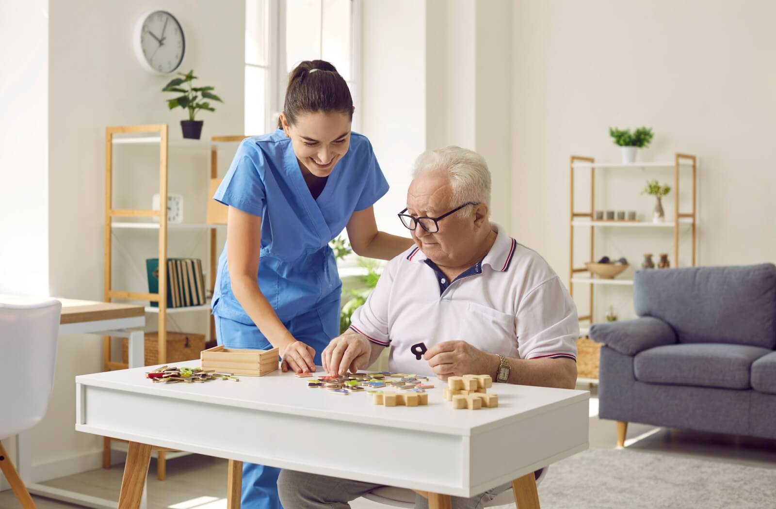 caregiver helping a senior with a puzzle in memory care