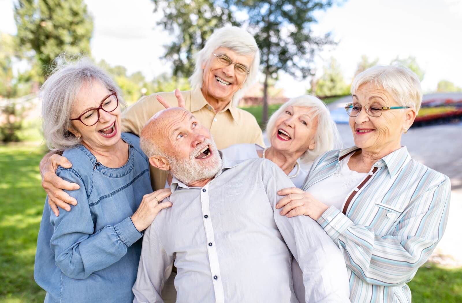 group of seniors having fun and posing in senior living community